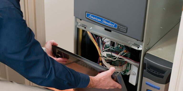 tech working on an american standard furnace